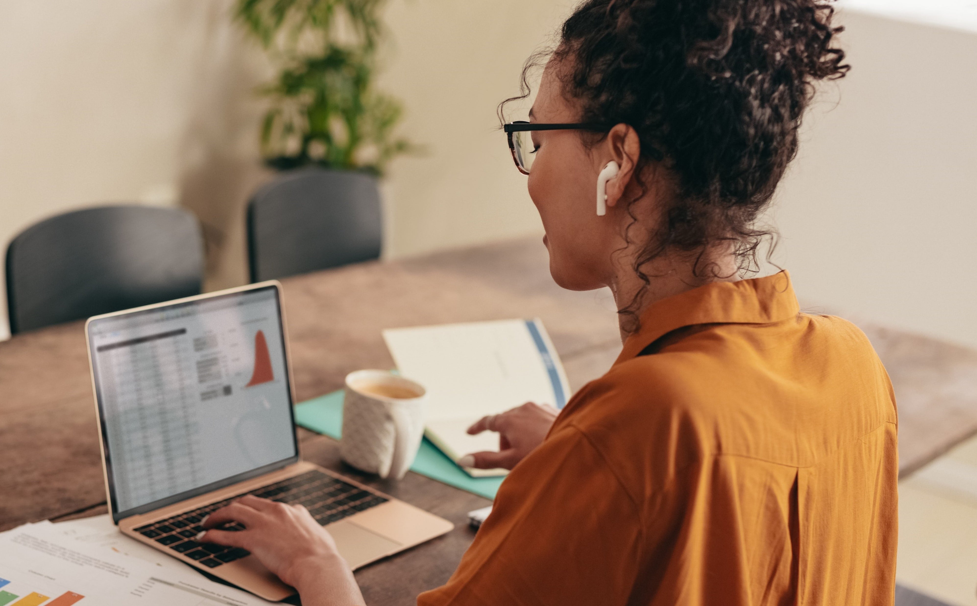 Female employee analysing analytics on laptop